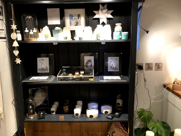 photo of shelves with jars, prints, and candles