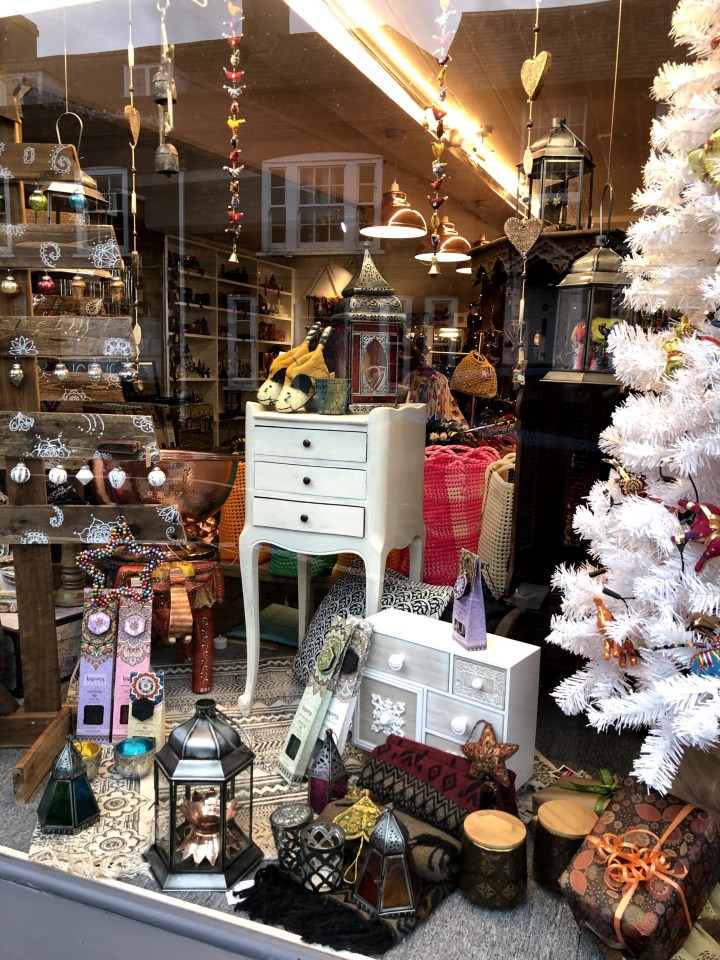 shop front with white tree , ornaments and small items of furniture