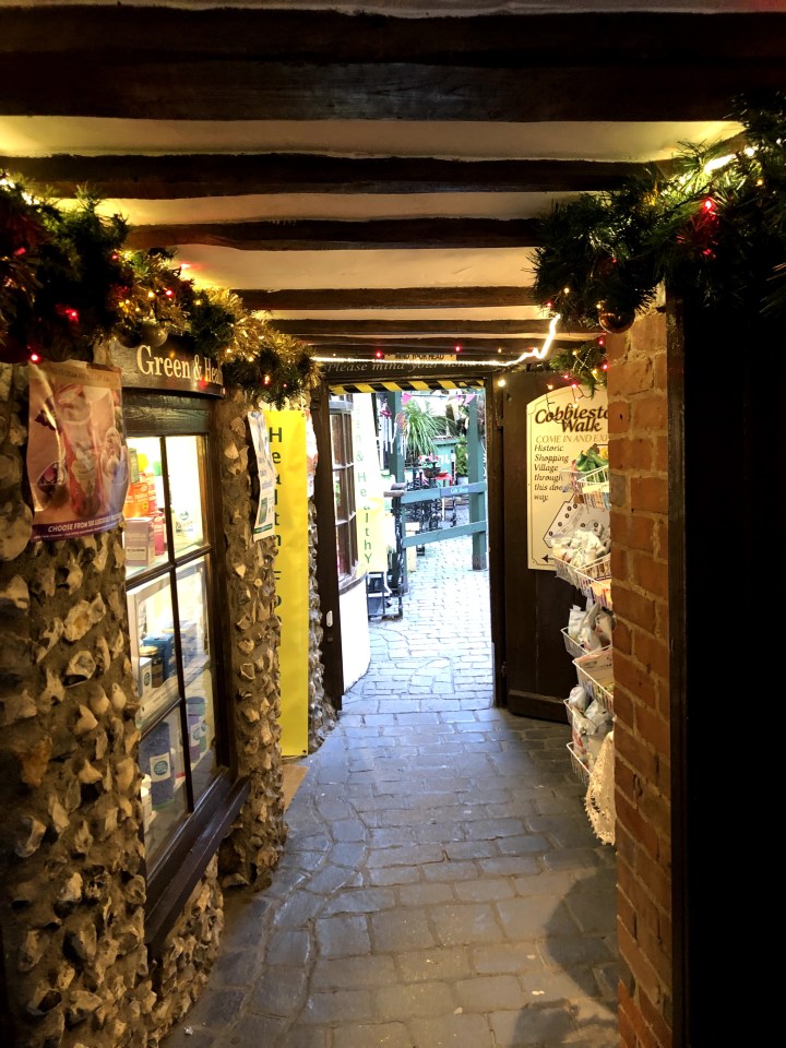 photo of small paved pathway between huts in a quaint shopping area