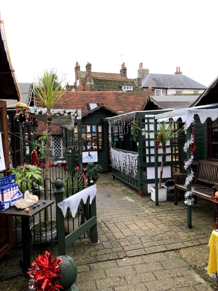photo of small paved pathway between huts in a quaint shopping area